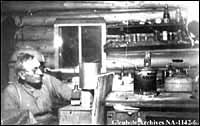 Photo - Interior view of shack with samples of tar sands and extractions, Fort McMurray, Alberta, 1920